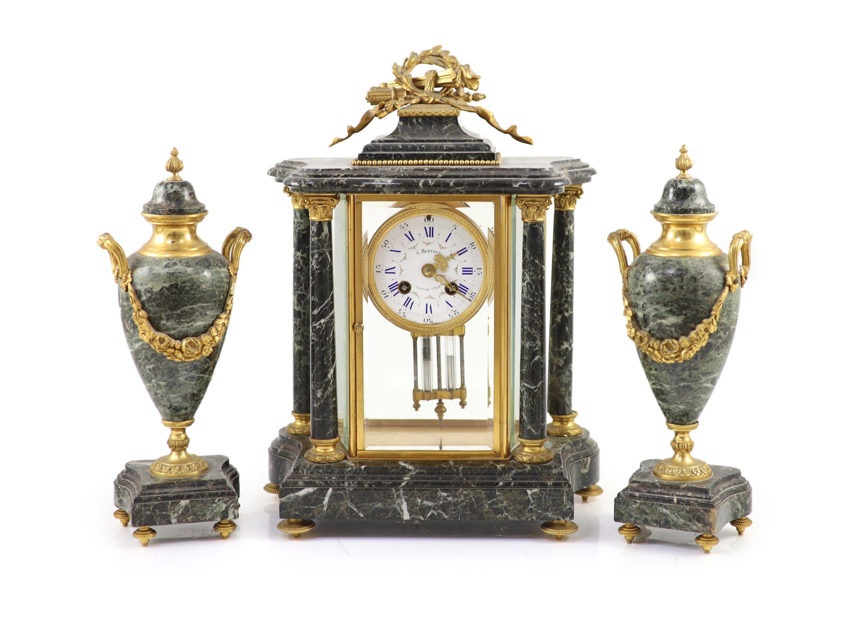 A 19th century French ormolu mounted black variegated three piece clock garniture H 38cm. W 27cm. D 14cm. The urns 31cm high.